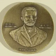 Mosiężny medalion z reliefowym popiersiem brodatego mężczyzny w garniturze